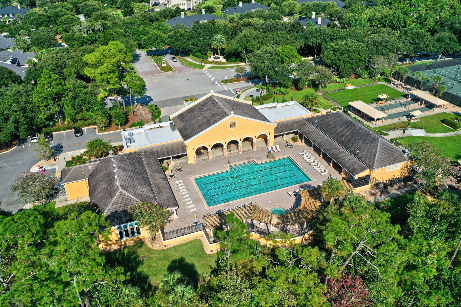 Aerial of the Grand Haven Village Center — resort-style pool, tennis courts, and clubhouse